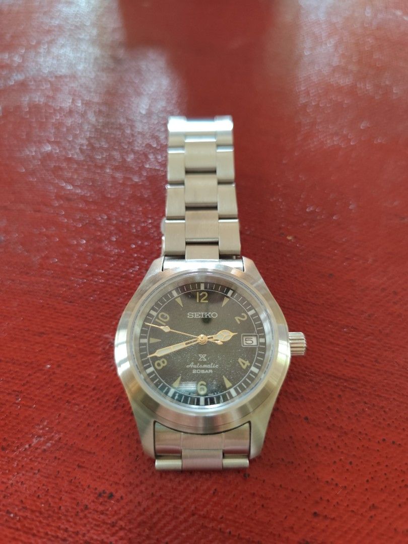 Seiko Baby Alpinist Mod (Category: Men's Watches) located in Davao. Submitted by papa1919 (Listing ID 1405349163, Image 3). Description: Brushed stainless steel case 39.7mm case diameter Seiko 7s26 automatic movement Sandy green textured dial Screwdown crown.