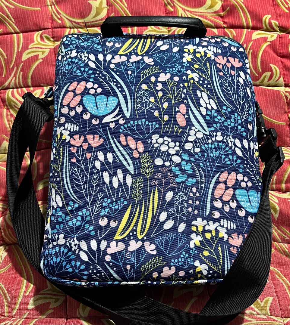 Tablet Sleeve/ Shoulder Bag (Category: Shoulder Bags) located in Quezon City. Submitted by melalog (Listing ID 1405521745, Image 2). Description: Tablet sleeve/shoulder bag in a floral print. It has a main compartment and a front pocket for organization. The bag includes a handle and an adjustable shoulder strap. The interior is a light gray color. Selling for 400 plus shipping. Pm if interested. ..