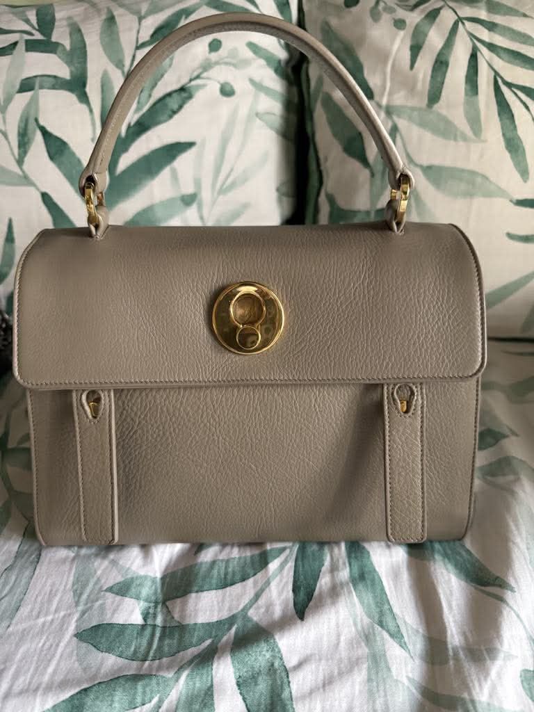 Yves Saint Laurent (YSL) Muse Two (Category: Luxury Bags & Wallets) located in Manila. Submitted by ivy_authenticshop (Listing ID 1405377466, Image 2). Description: - YSL handbag in Taupe/Tan Color - Top handle and detachable shoulder strap - Gold-tone clasp and hardware - Made of leather - Flap closure - Structured silhouette.