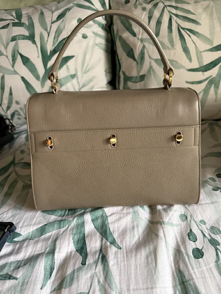 Yves Saint Laurent (YSL) Muse Two (Category: Luxury Bags & Wallets) located in Manila. Submitted by ivy_authenticshop (Listing ID 1405377466, Image 3). Description: - YSL handbag in Taupe/Tan Color - Top handle and detachable shoulder strap - Gold-tone clasp and hardware - Made of leather - Flap closure - Structured silhouette.