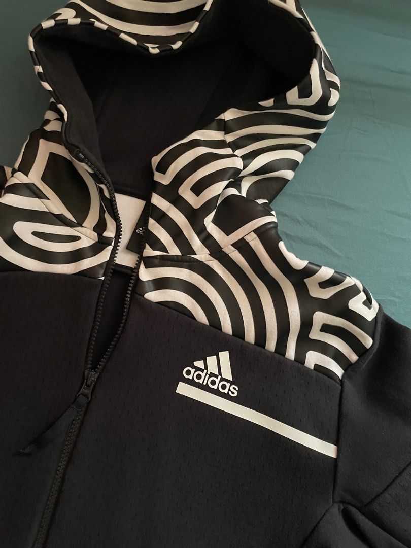 Adidas Full Zip Hoodie (Category: Hoodies) located in Manila. Submitted by lrj_stuff (Listing ID 1405661333, Image 1). Description: - Adidas full zip hoodie - Unique black and white patterned hood - Black color with textured fabric - Full zip closure - Two side pockets with zippers - Adidas logo on chest - Size tag visible in photos.