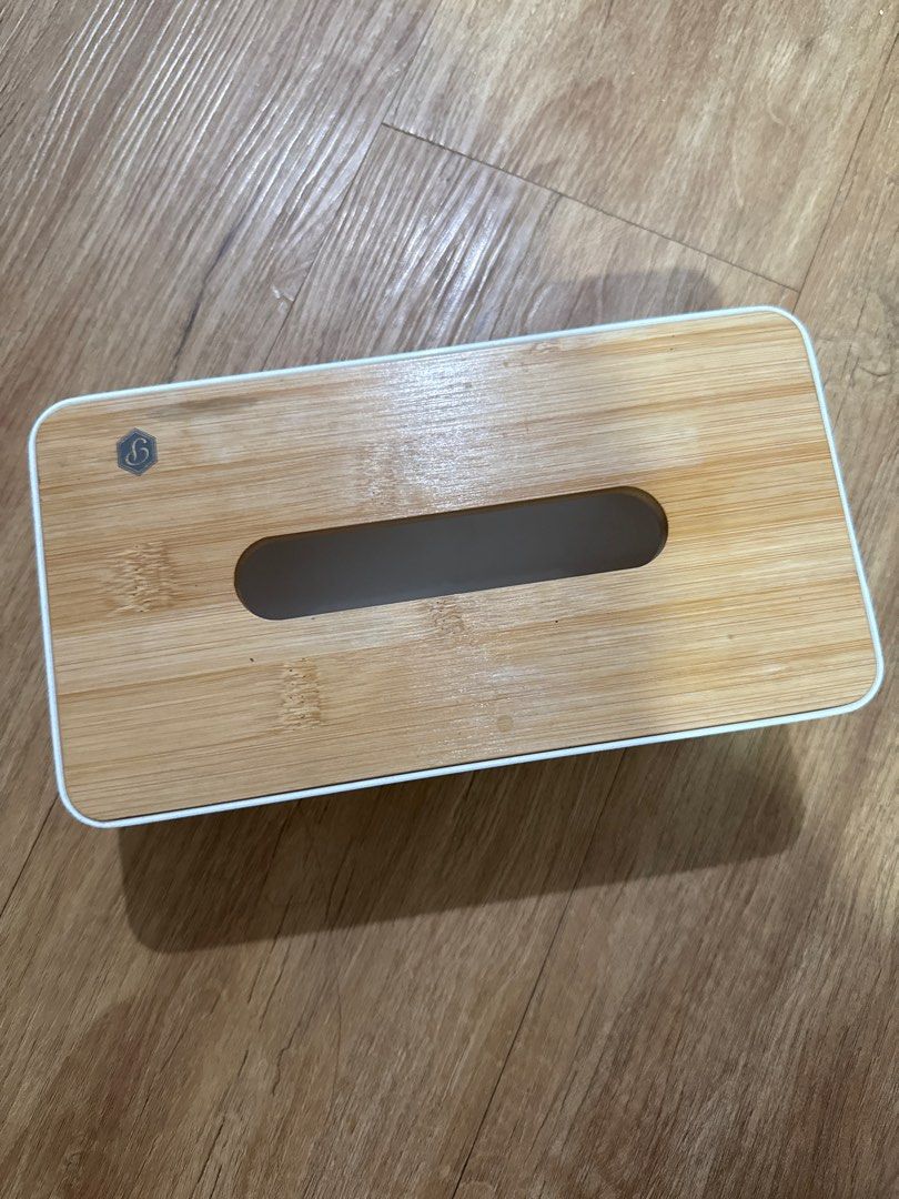 Wooden Bamboo Tissue Box (Category: Storage Boxes & Baskets) located in Mandaluyong City. Submitted by merisellsyouwhat (Listing ID 1405640775, Image 1). Description: - Natural bamboo tissue box - Features a white sides plastic material - Rectangular shape - Long, oval opening for easy tissue access - Simple, minimalist design - Suitable for various home decor styles - Standard size, fits standard tissue boxes.