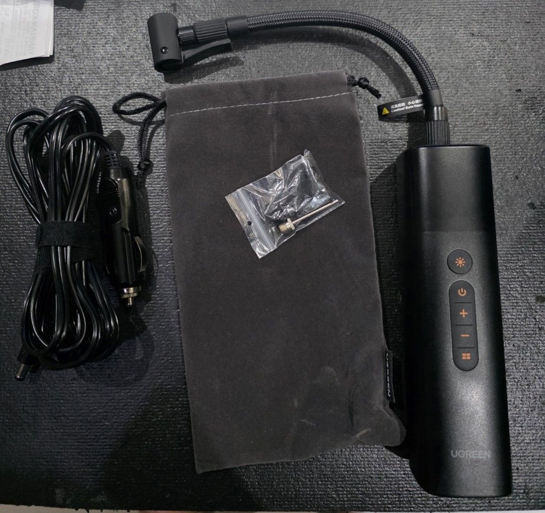 Bnew UGREEN Portable Tire Inflator ET501 (Category: Mags and Tires) located in Makati City. Submitted by harrys08 (Listing ID 1405669659, Image 2). Description: UGREEN Portable Tire Inflator ET501. Features fast inflation, precise pressure detection, and advanced safety. Includes a car charger, a storage bag, and multiple nozzle attachments. The device has an LCD screen and multiple buttons for easy operation. It is designed for multiple tire typ