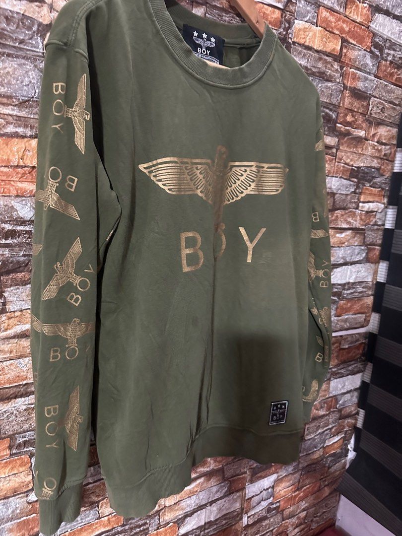 Boy London Eagle Graphic Sweatshirt (Category: Coats, Jackets and Outerwear) located in Paranaque City. Submitted by jer27.jpn (Listing ID 1405585876, Image 2). Description: - Olive green Boy London sweatshirt - Eagle graphic on front - Brand name on sleeves - Small logo patch - Crew neck - Long sleeves - Size tag visible - Made in the United Kingdom Size W22,L28 Sale 320.
