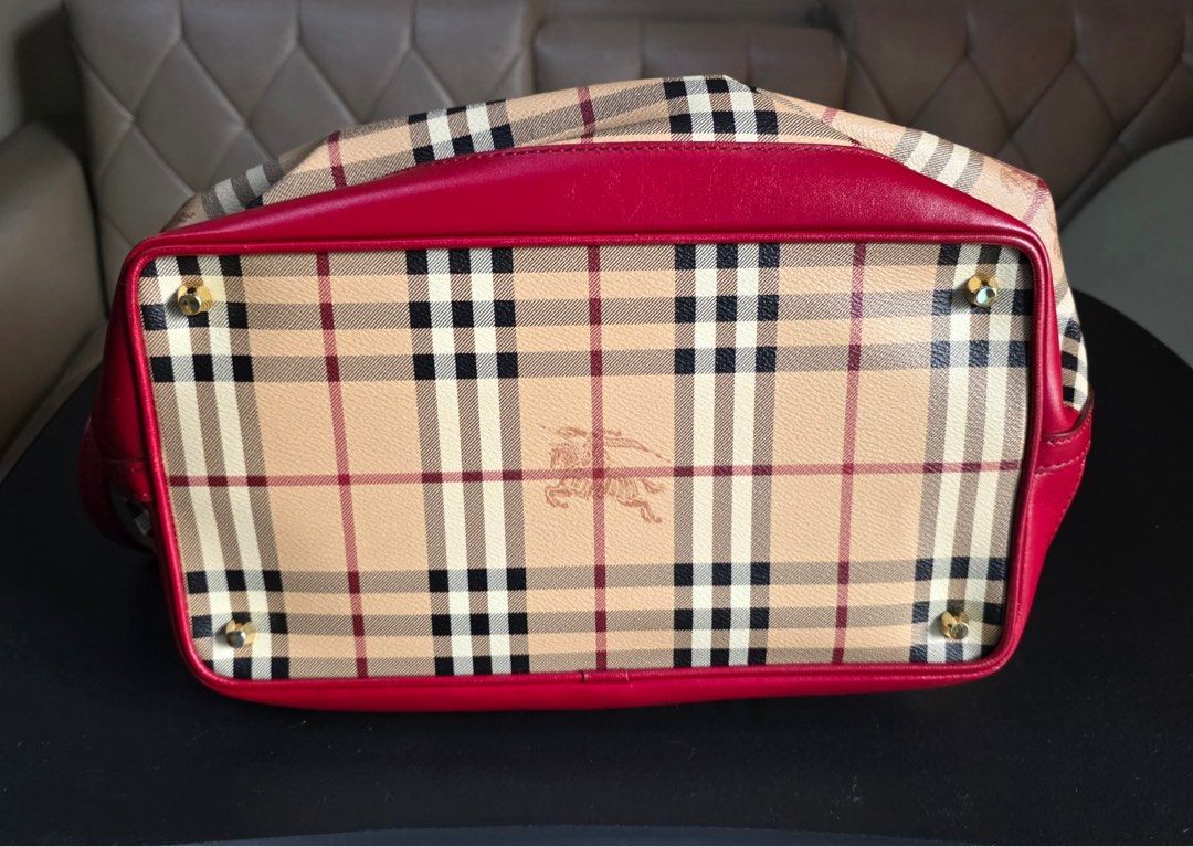 Burberry Checkered Handbag with Red Accents (Category: Luxury Bags & Wallets) located in Manila. Submitted by d_serr (Listing ID 1405645269, Image 2). Description: Burberry Medium Golderton tote bag Burberry Medium Golderton tote bag featuring the brand's signature Haymarket check pattern and red leather trims. The bag is made of PVC with leather accents and has gold-tone hardware. It features two rolled top handles and an adjustable shoulder str