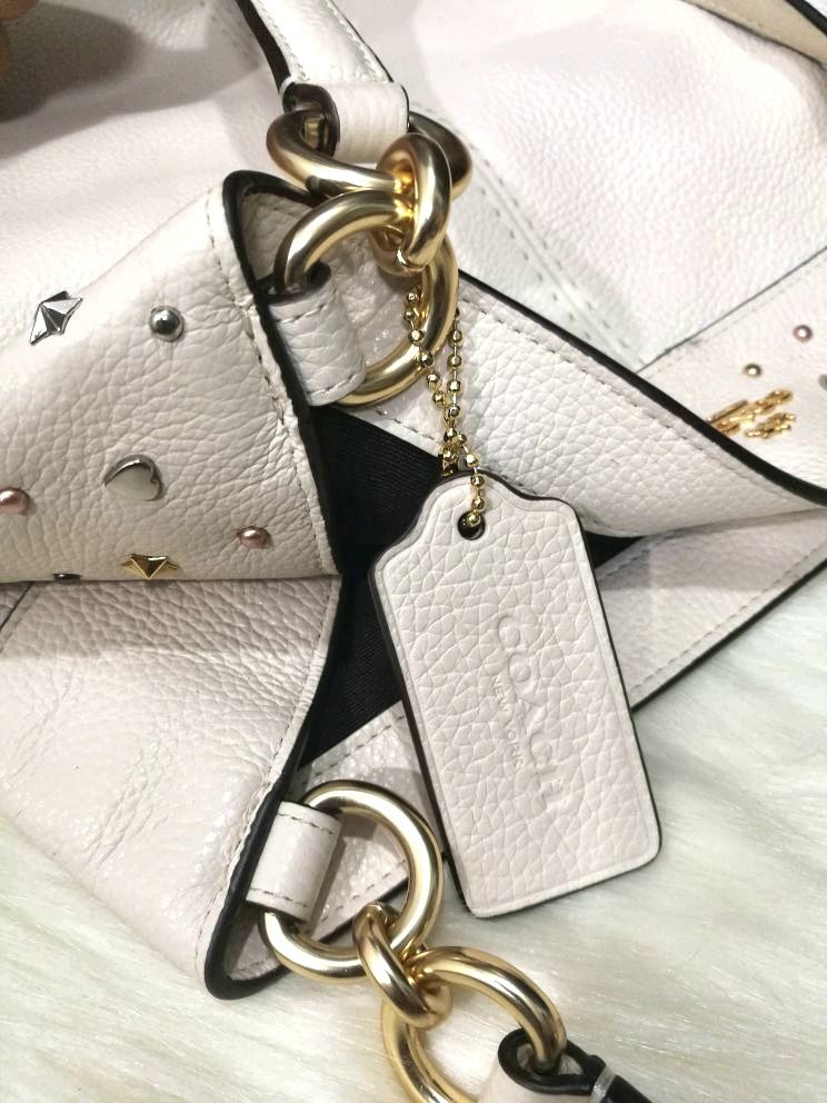 Coach Star Studded Lexy Bag (Category: Luxury Bags & Wallets) located in Quezon City. Submitted by katebutters (Listing ID 1405594248, Image 3). Description: Authentic COACH Star Studded Lexy tote. Brand new with tags in chalk off-white color. Calf leather, gold hardware, inner zipped pocket, two pockets inside, made in vietnam. Bought this in the US for $475 (Php 23,750) stored and never got to use it. Great for gifting. Original dustbag include