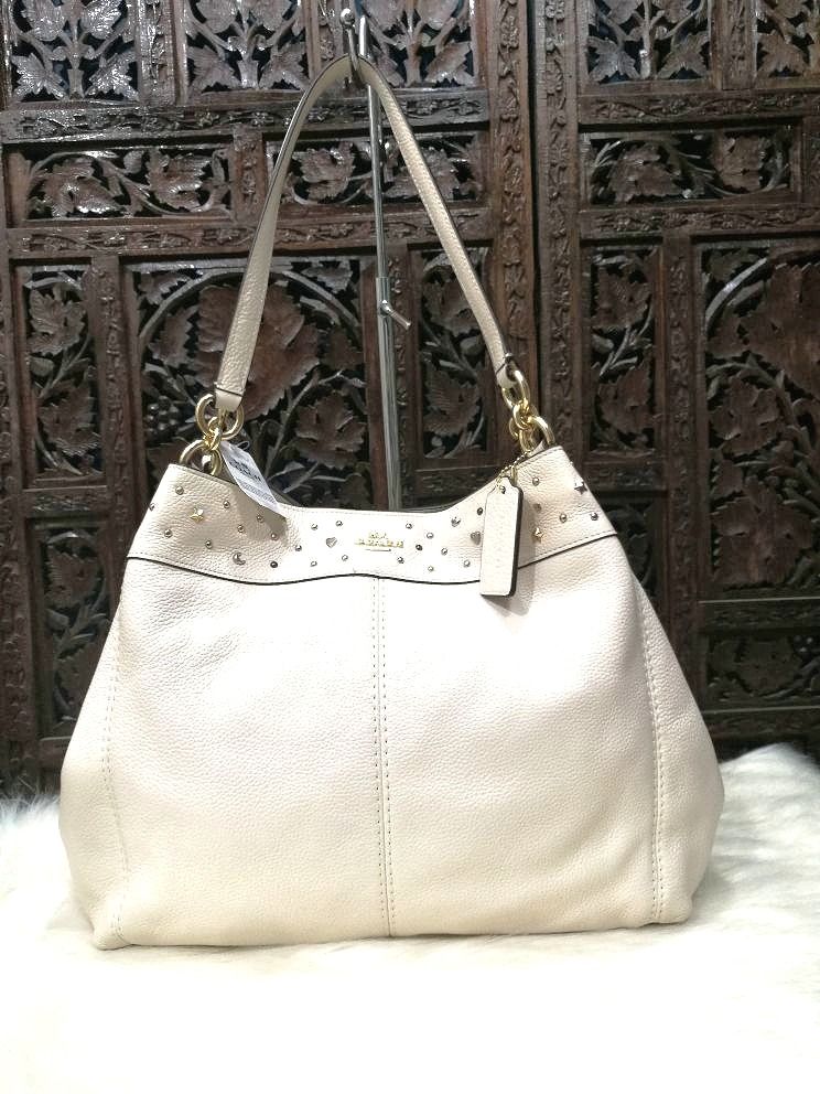 Coach Star Studded Lexy Bag (Category: Luxury Bags & Wallets) located in Quezon City. Submitted by katebutters (Listing ID 1405594248, Image 1). Description: Authentic COACH Star Studded Lexy tote. Brand new with tags in chalk off-white color. Calf leather, gold hardware, inner zipped pocket, two pockets inside, made in vietnam. Bought this in the US for $475 (Php 23,750) stored and never got to use it. Great for gifting. Original dustbag include