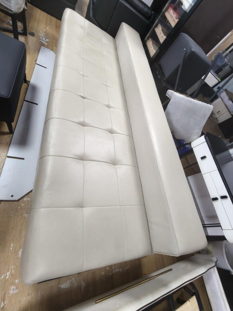 Cream-colored Modern Sofa (Category: Sofas) located in Pasay City. Submitted by vonneq (Listing ID 1404093574, Image 2). Description: - Cream-colored sofa - Modern design - Tufted seat - Long backrest - Smooth, leather-like material - Rectangular shape - Spacious - Ideal for living room or office.