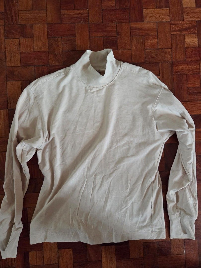Heattech Long Sleeve Turtleneck (Category: Tshirts & Polo Shirts ) located in Quezon City. Submitted by frankstuff (Listing ID 1405558759, Image 1). Description: - Cream-colored long sleeve shirt - Features a turtleneck collar - Made of soft, lightweight fabric - Simple, classic design - Perfect for layering.