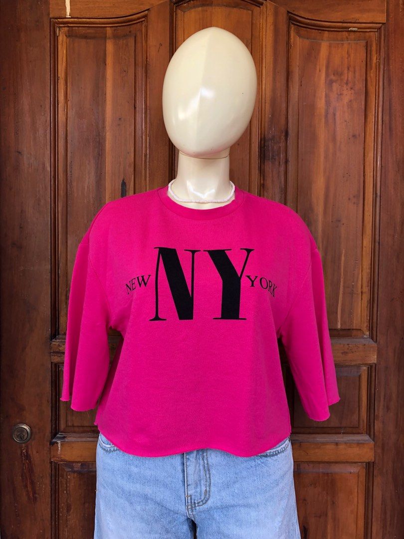 H&M Divided NY top (Category: Blouses) located in Naga. Submitted by ajmaq (Listing ID 1405661294, Image 3). Description: - H&M Divided sweatshirt - Bright pink color - "NY" graphic - Size: Small on tag but it can fit up to large - Cropped, raw hem - 3/4 sleeves - Crew neck - Perfect for a casual look.
