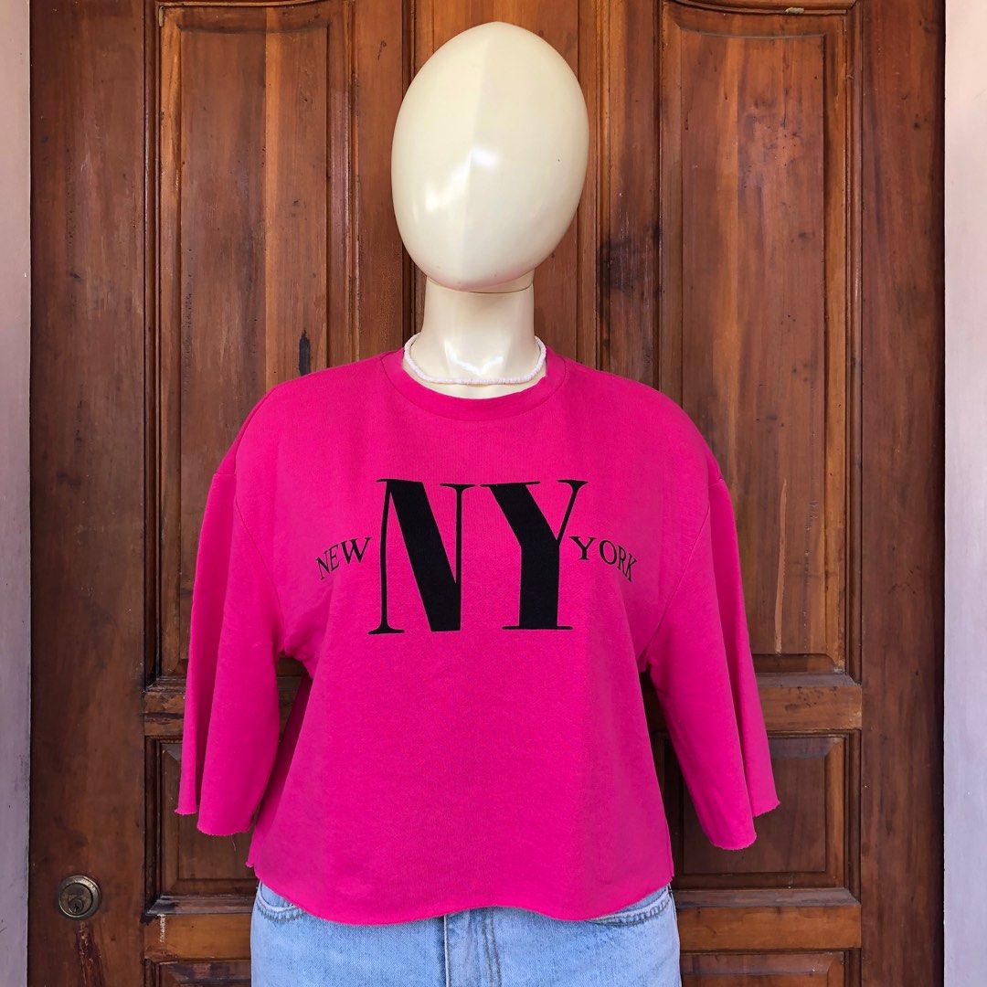 H&M Divided NY top (Category: Blouses) located in Naga. Submitted by ajmaq (Listing ID 1405661294, Image 2). Description: - H&M Divided sweatshirt - Bright pink color - "NY" graphic - Size: Small on tag but it can fit up to large - Cropped, raw hem - 3/4 sleeves - Crew neck - Perfect for a casual look.