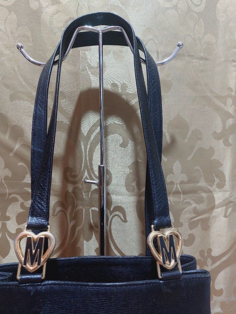 Moschino Vertical Shoulder Bag (Category: Luxury Bags & Wallets) located in Muntinlupa City. Submitted by sakurambo_des (Listing ID 1405636591, Image 3). Description: Auth.Moschino By Cheap & Chic Vertical Shoulder Bag Leather/Satin signature interior 2 compartment 1 Zipper center compartment 10½"×11" dimension 13" handle drop measure. in very good condition..