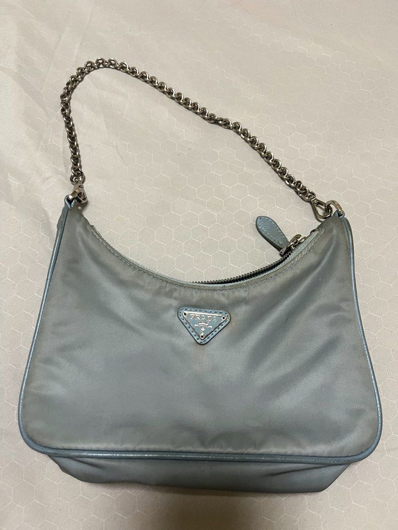 Prada Re-Edition 2000 Mini Bag (Category: Luxury Bags & Wallets) located in Pasig City. Submitted by jadeeeore (Listing ID 1405677627, Image 2). Description: - Authentic Prada Re-Edition 2000 Mini Bag - Color: Light Dusty Blue - Features a chain strap - Small Prada logo on the front - Interior Prada Milano label - Zipper closure - Made of durable nylon material - Missing parts thus the low price - Guaranteed authentic.