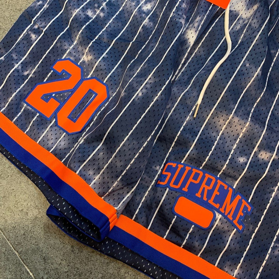 Supreme Newyork pinstripes shorts (Category: Shorts) located in Pasig City. Submitted by paymelikelandlord (Listing ID 1405586255, Image 3). Description: - Supreme basketball shorts - Color: Navy blue with white stripes - Features: "20" in orange (left leg), "SUPREME" logo (right leg) - Details: Drawstring waistband, orange and blue trim - Size: XL Supreme Newyork pinstripes shorts Excellent condition like new deadstock ❗️ No hidden issue no flaw