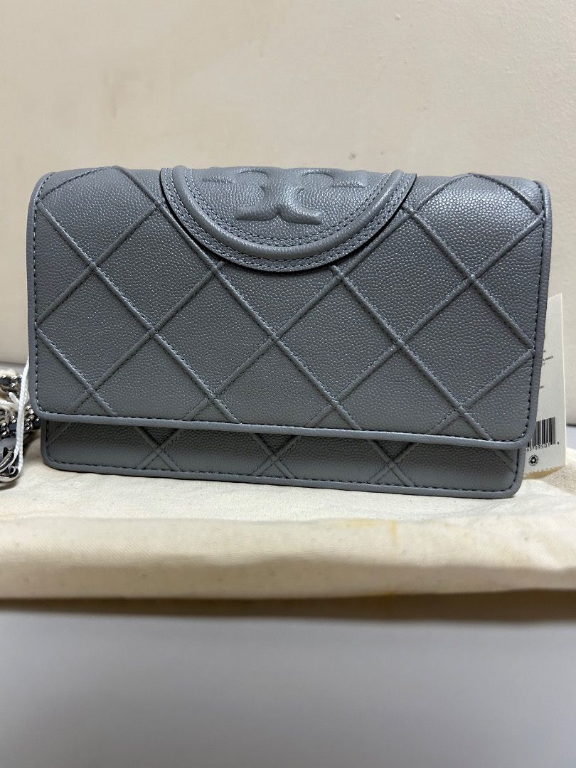 Tory Burch Kira Chevron Chain Wallet (Category: Luxury Bags & Wallets) located in Muntinlupa City. Submitted by curatedbycj (Listing ID 1405704814, Image 1). Description: - Tory Burch Kira Chevron Chain Wallet - Guaranteed Authentic - Gray color - Quilted design - With Removable Chain strap - Flap magnetic closure with Tory Burch logo - Interior: Multiple compartments and zippered pocket - Includes dust bag and tags.