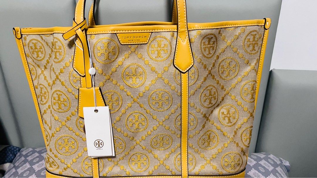 Tory Burch Perry T Monogram Triple-Compartment Tote (Category: Luxury Bags & Wallets) located in Quezon City. Submitted by kishey (Listing ID 1405640139, Image 1). Description: - rub in one corner but very minimal lang • Height: 11.4 inches to 11.5 inches (29.0 cm) • Length: 14.2 inches to 14.3 inches (36.0 cm) • Depth: 5.3 inches (13.4 cm) - Authentic Tory Burch tote bag - Yellow leather trim and handles - Monogram pattern - Interior zippered po