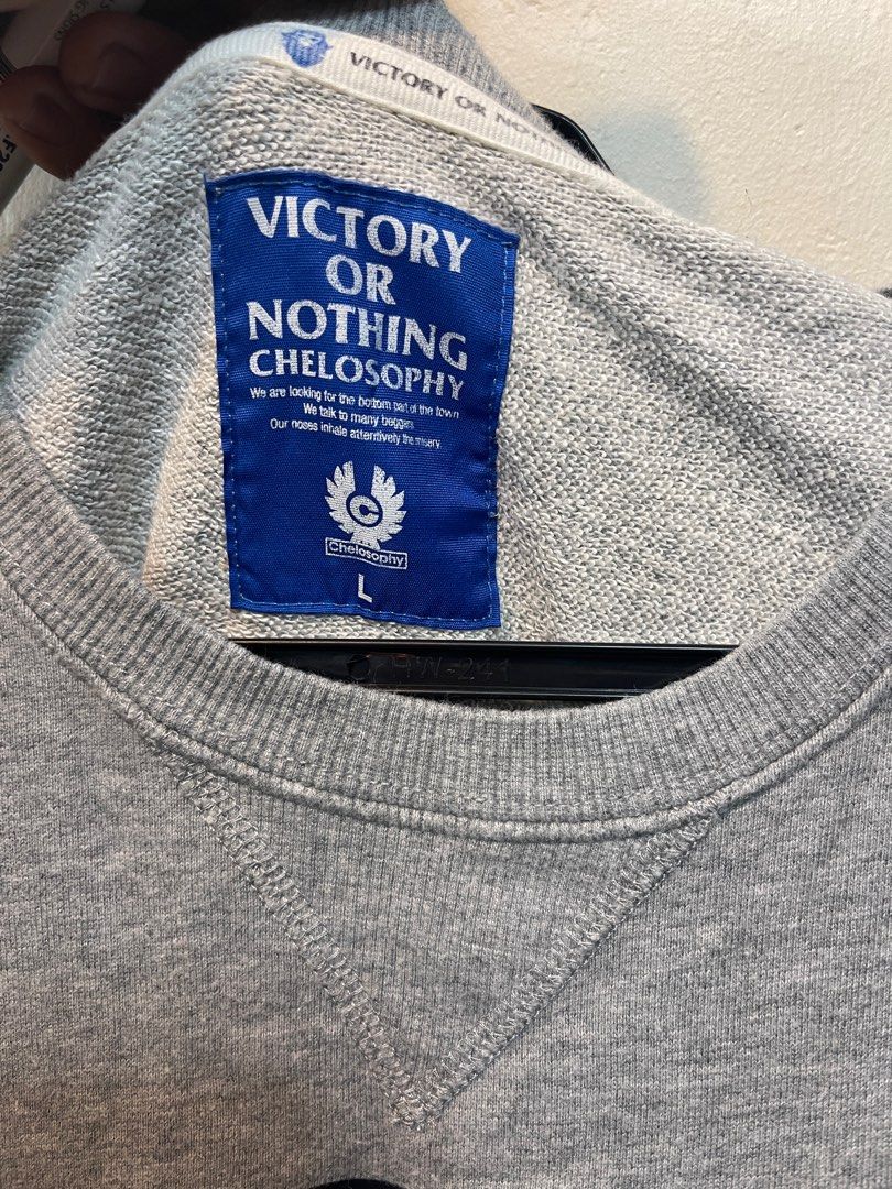Victory or Nothing Chelosophy Sweatshirt - Size L (Category: Coats, Jackets and Outerwear) located in Lupao. Submitted by jennylynda42204 (Listing ID 1405650936, Image 2). Description: - Victory or Nothing Chelosophy sweatshirt - Gray color - Size: L - Features a large black graphic - Crew neck - Long sleeves.