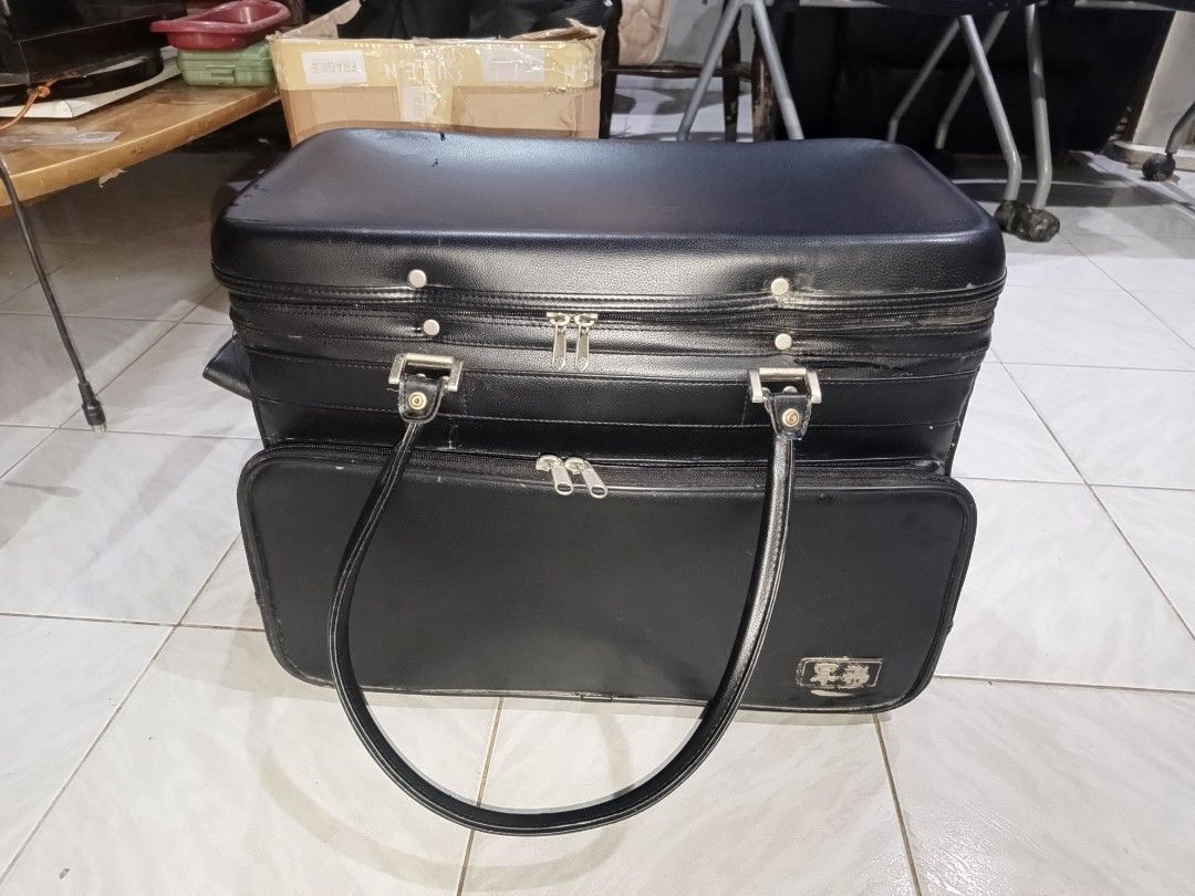 Vintage Black Travel Bag (Category: Luxury Bags & Wallets) located in Cebu City. Submitted by turuuru8992423 (Listing ID 1405599172, Image 2). Description: 🛍️ Vintage Black Hard-Shell Carry Case / Suitcase (Approx. 50cm) Details: For sale is a unique and sturdy vintage hard-shell carry case or small suitcase. This piece has a classic, retro look and appears to be made of a durable material, possibly a form of textured leather or vinyl over a har