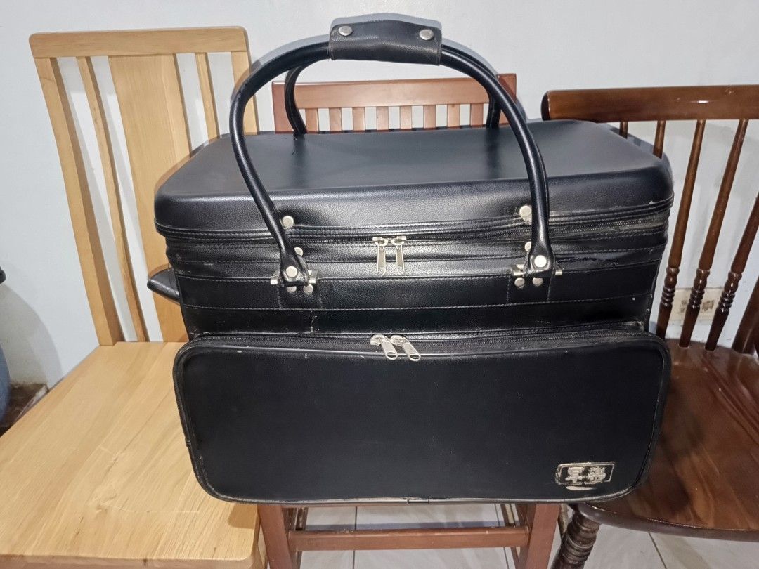 Vintage Black Travel Bag (Category: Luxury Bags & Wallets) located in Cebu City. Submitted by turuuru8992423 (Listing ID 1405599172, Image 1). Description: 🛍️ Vintage Black Hard-Shell Carry Case / Suitcase (Approx. 50cm) Details: For sale is a unique and sturdy vintage hard-shell carry case or small suitcase. This piece has a classic, retro look and appears to be made of a durable material, possibly a form of textured leather or vinyl over a har