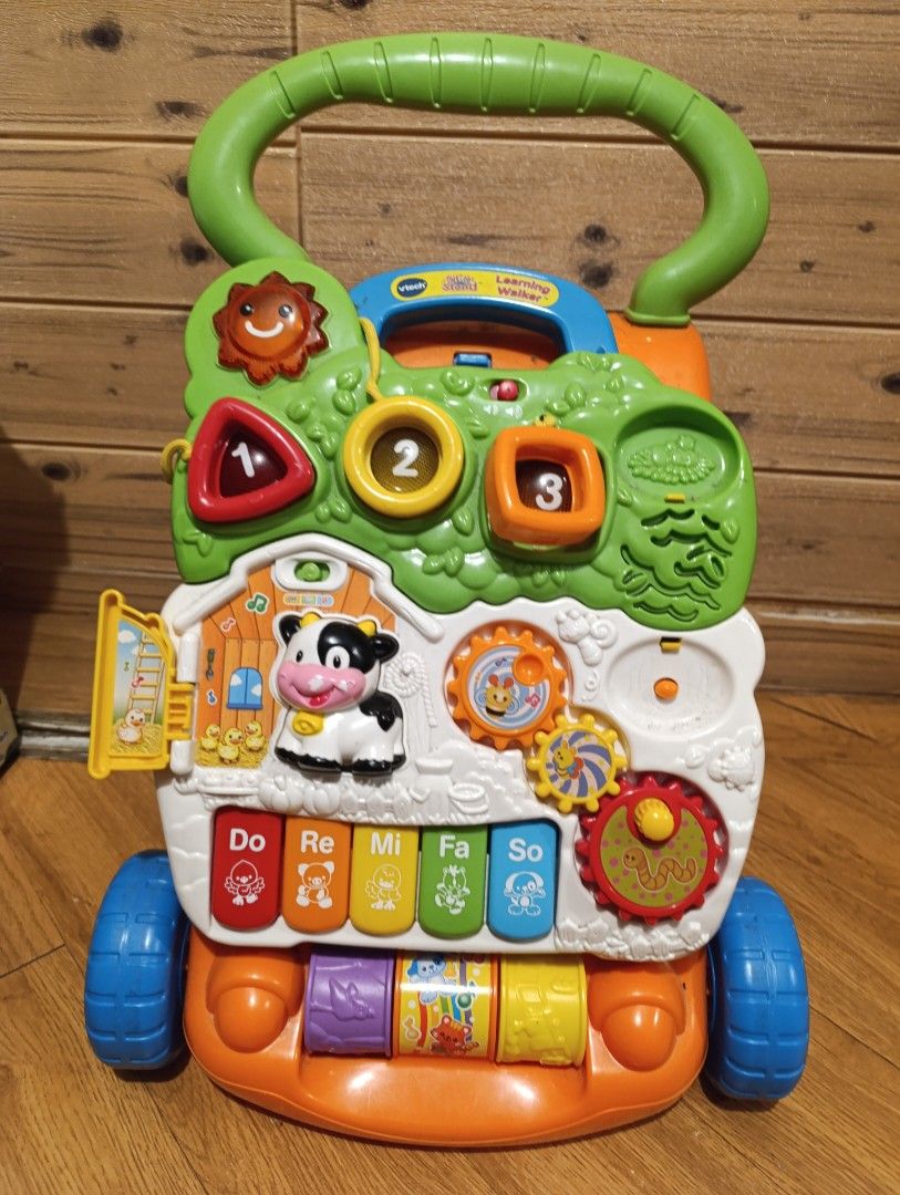 VTech Sit-to-Stand Learning Walker (Category: Infant Playtime) located in Cavite. Submitted by hand.me.loved (Listing ID 1405597592, Image 1). Description: VTech Sit-to-Stand Learning Walker is a fun and interactive toy for babies. It features a variety of activities, including a piano keyboard, colorful buttons, and spinning gears. The walker also has a farm theme with animal sounds and melodies. It helps babies develop motor skills and learn ab