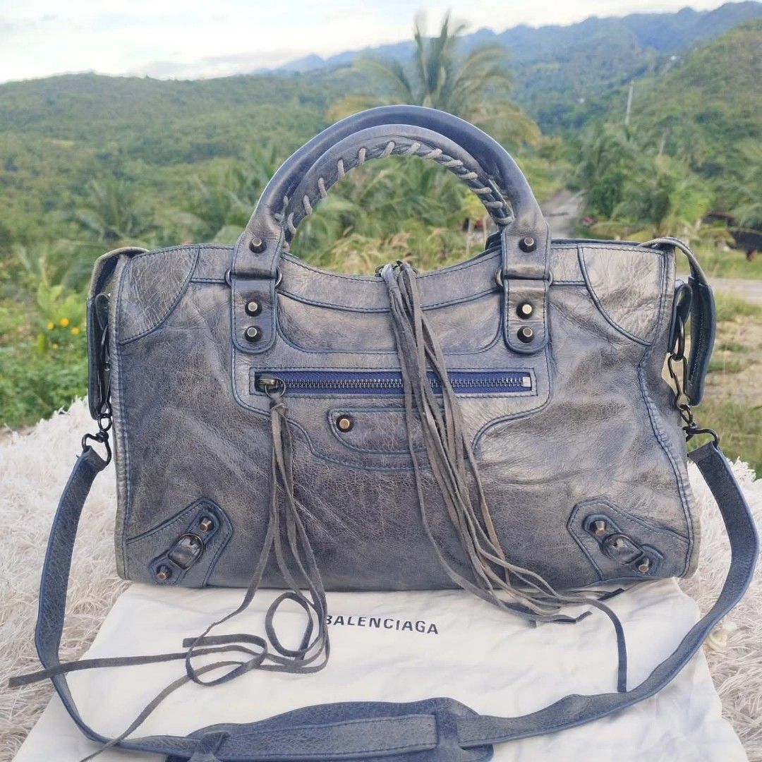 Balenciaga Classic City Handbag (Category: Luxury Bags & Wallets) located in Cebu City. Submitted by tlisurplus (Listing ID 1405835272, Image 1). Description: Balenciaga Classic City handbag - Distressed blue-grey leather - Braided top handles - Detachable shoulder strap - Multiple zip compartments - Includes dust bag - Interior zip pocket - Leather tag with brand details and serial number - Made in Italy.