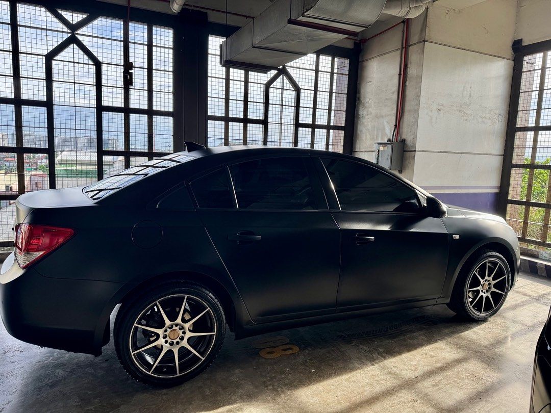 Chevrolet Cruze 1.8 LT (A) (Category: Used Cars) located in Quezon City. Submitted by prinscessa (Listing ID 1394262135, Image 2). Description: • 87,000km mileage • 1.8L 4-cylinder DOHC engine • 6-speed automatic transmission • Front and rear disc brakes with ABS • Wrapped in satin/matte black finish • Android Auto + Apple CarPlay • Upgraded touchscreen infotainment • 70mai rearview dashcam S500 set • 6-speaker audio system • Full detailing (inte