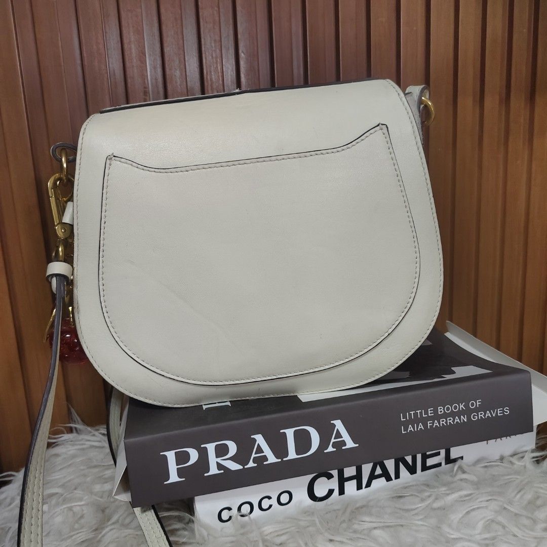 Chloe Drew Shoulder Bag (Category: Luxury Bags & Wallets) located in Danao, Cebu. Submitted by anne_2016143 (Listing ID 1405765599, Image 3). Description: - Chloe Drew shoulder bag - Off-white color - Saddle bag design with flap closure - Detachable shoulder strap - Includes cherry charm - Interior pocket - Made in Italy - Minor defect on top of bag .