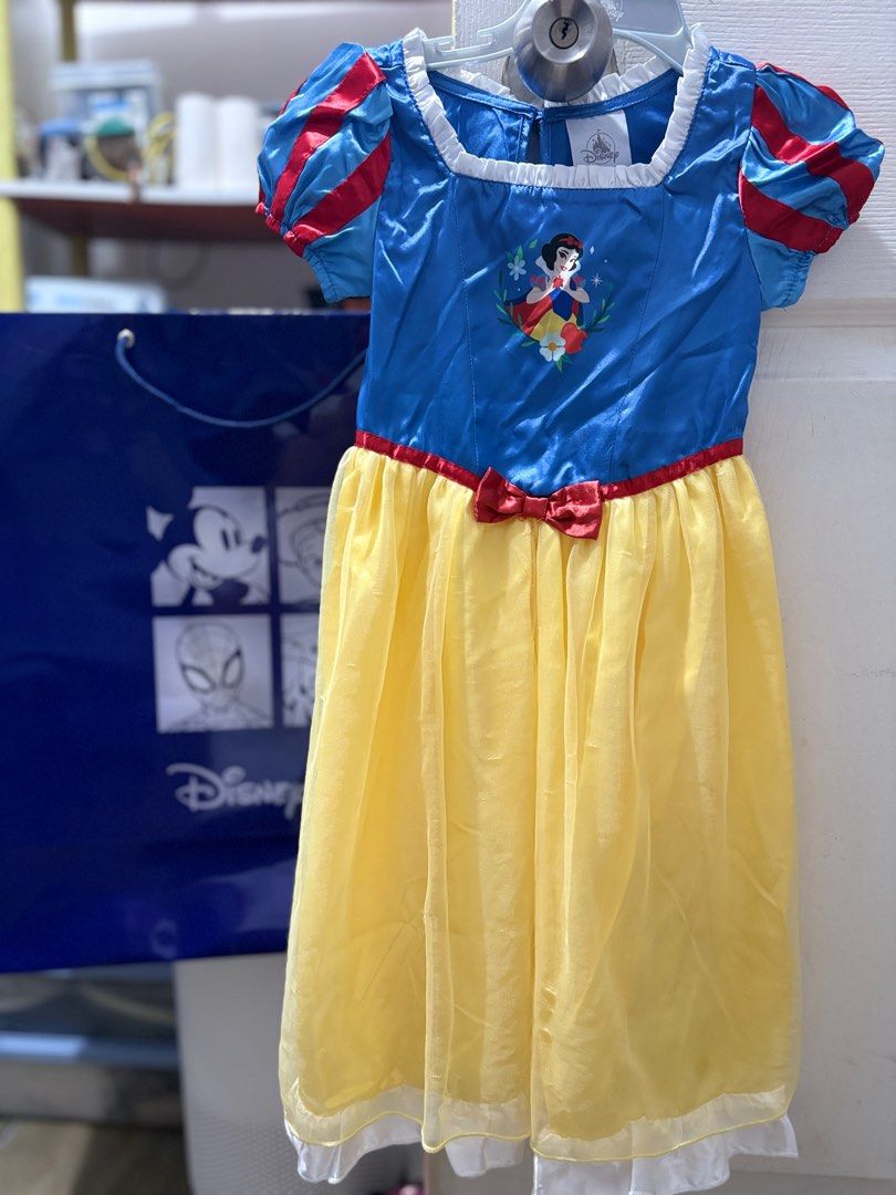 Disney Snow White Dress (Category: Babies & Kids Fashion) located in General Trias. Submitted by whimsylist (Listing ID 1405819191, Image 3). Description: - Authentic Disney Snow White dress - Blue bodice with Snow White graphic - Red bow detail - Yellow skirt - Puff sleeves with red accents - Includes Disney store Used Once donly for Halloween Party. Dress is in good condition.