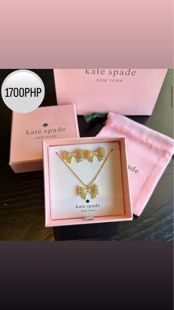 Kate Spade Bow Necklace and Earrings Set (Category: Necklaces) located in Baliuag. Submitted by zuuki (Listing ID 1405786844, Image 1). Description: - Kate Spade jewelry set - Gold-toned bow design - Features necklace and matching earrings - Small black spade detail - Includes original box, pink pouch, and paper bag - Price: 1700 PHP.