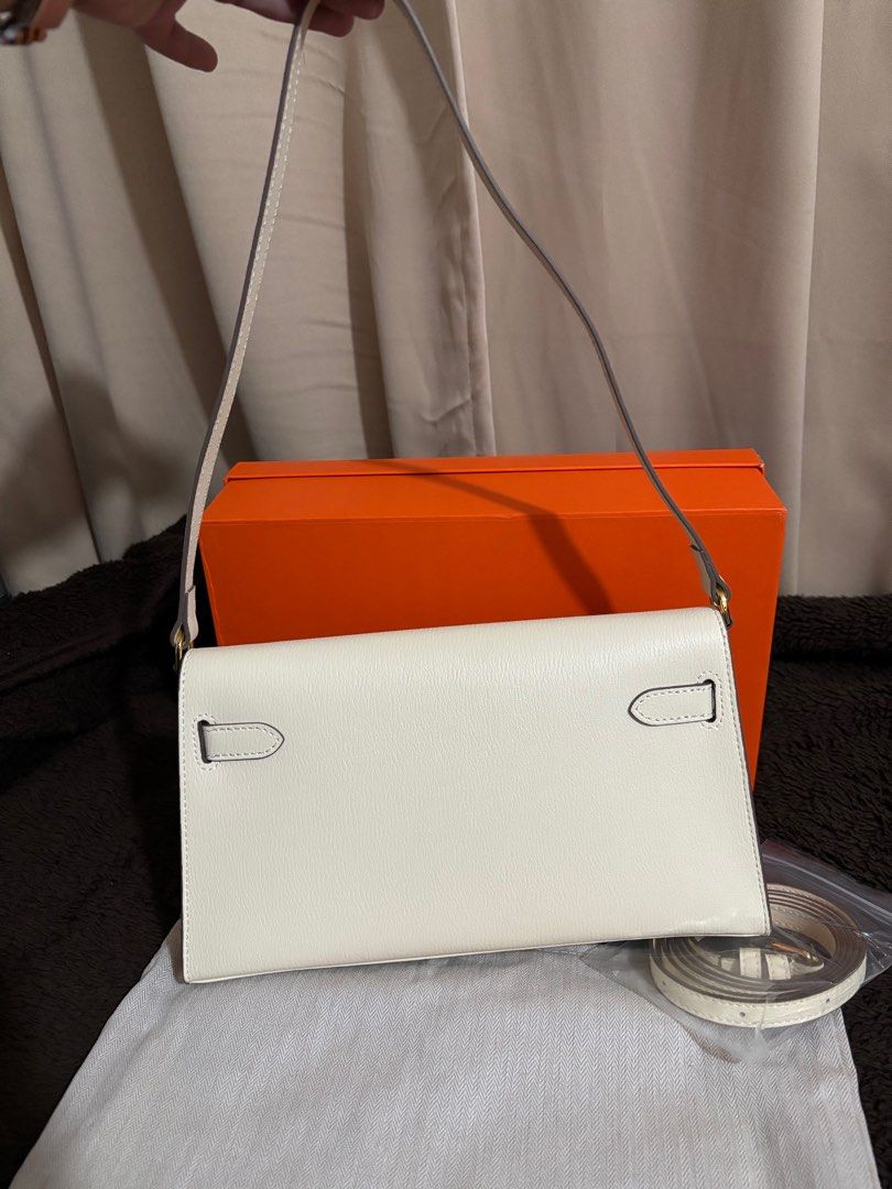 Kelly Elan Nata (Category: Luxury Bags & Wallets) located in Paranaque City. Submitted by declutterqueeen (Listing ID 1405876173, Image 2). Description: - Kelly Elan in Nata white - Gold-tone hardware - Detachable shoulder strap and crossbody strap included (2 straps) - Comes with dust bag and box -can be worn as shoulder bag or crossbody - no logo / stamping - made of genuine leather - Ideal for evening wear and special occasions.