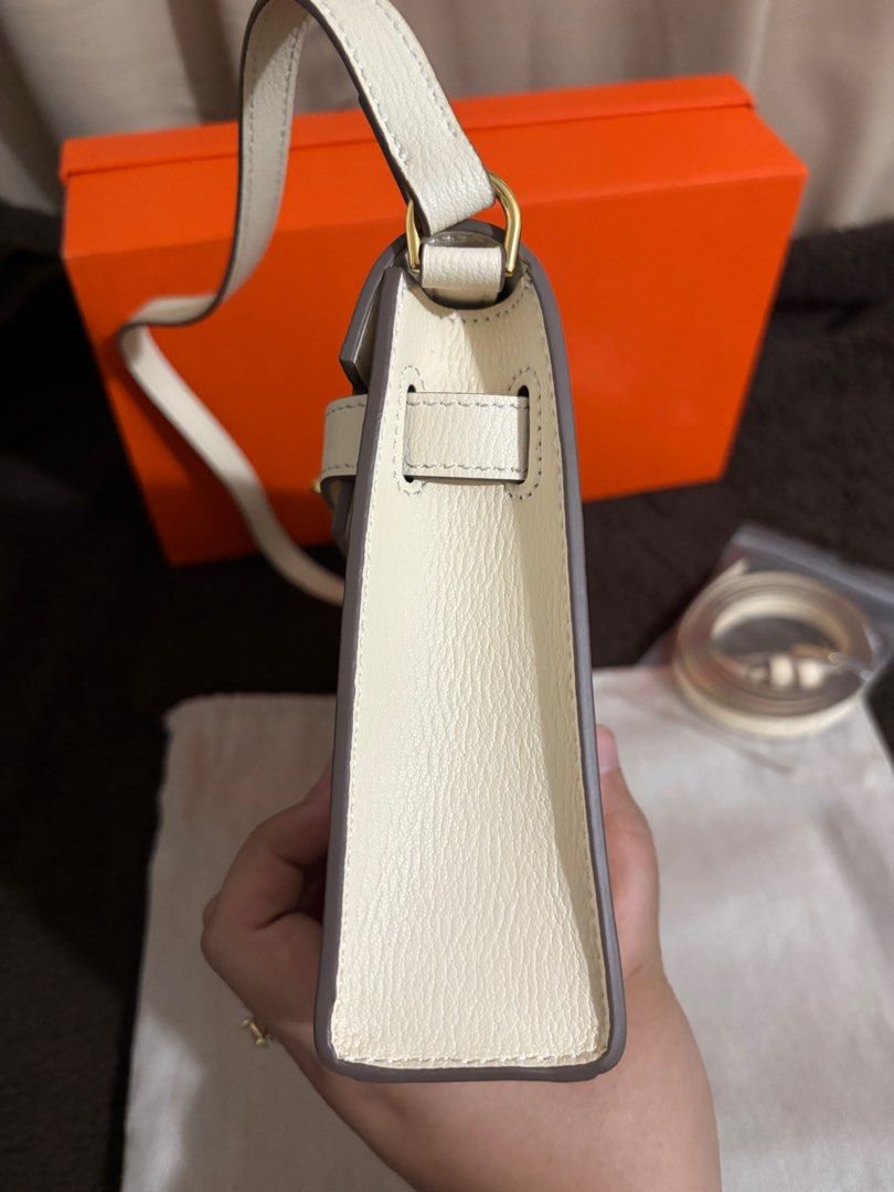 Kelly Elan Nata (Category: Luxury Bags & Wallets) located in Paranaque City. Submitted by declutterqueeen (Listing ID 1405876173, Image 3). Description: - Kelly Elan in Nata white - Gold-tone hardware - Detachable shoulder strap and crossbody strap included (2 straps) - Comes with dust bag and box -can be worn as shoulder bag or crossbody - no logo / stamping - made of genuine leather - Ideal for evening wear and special occasions.