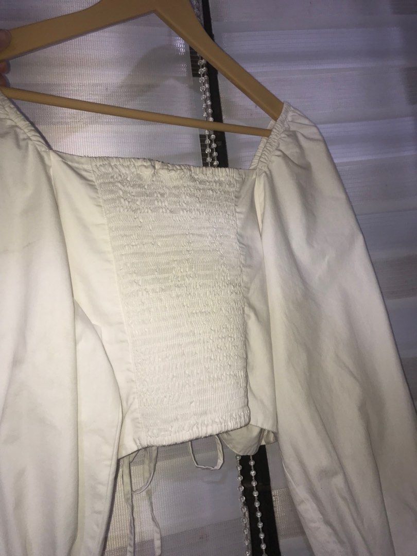 Levi's White Puff Sleeves Cropped Top (Category: Sleeveless) located in Makati City. Submitted by closet.declutterph (Listing ID 1405751860, Image 2). Description: - Levi's cropped top - White color - Size: L - Features a square neckline - Long sleeves - Ruched detail in the front - Smock at the back.