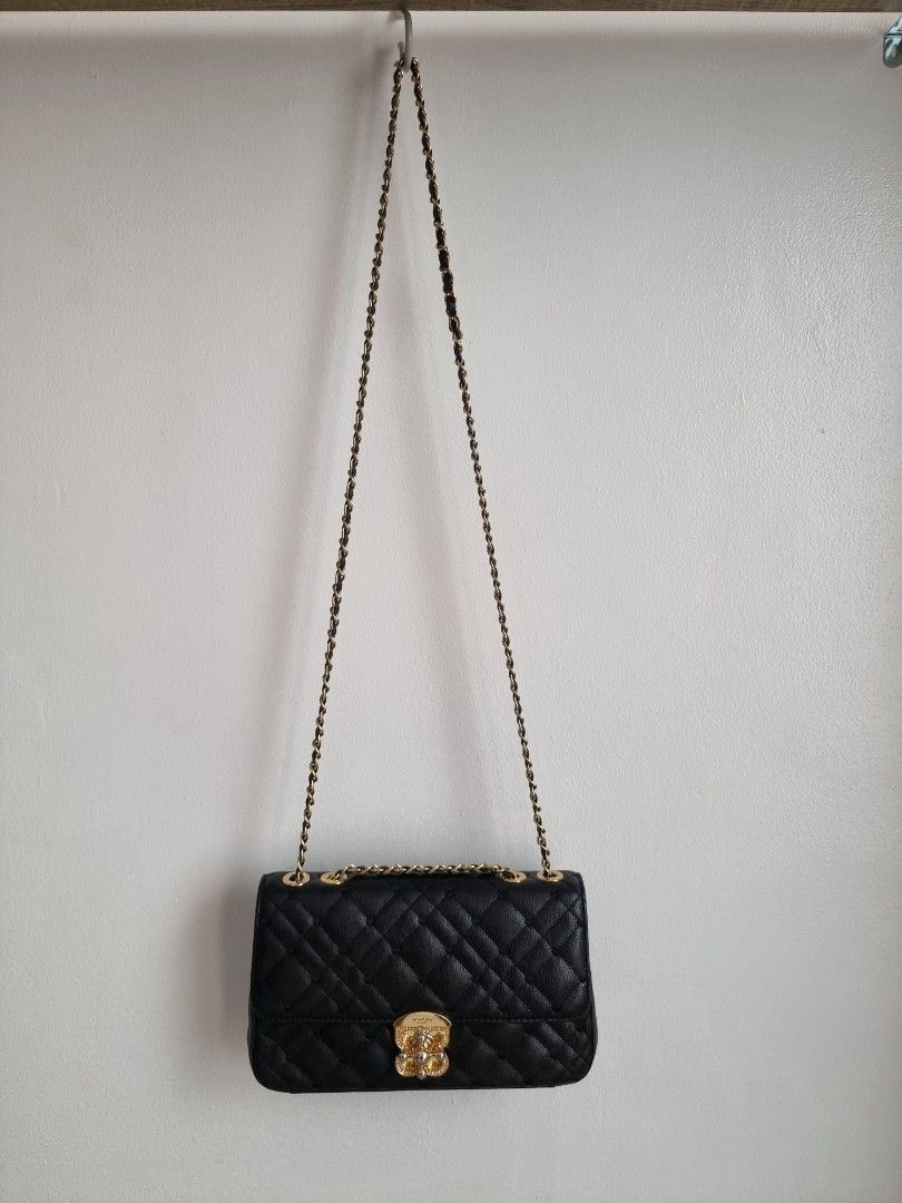 Lovcat Paris Black Quilted Chain Bag (Category: Luxury Bags & Wallets) located in Cebu City. Submitted by ohpetite (Listing ID 1405773860, Image 3). Description: - Lovcat Paris black quilted handbag - Cebu City - firstpayment basis - Gold-tone chain strap, hardware - a bit of fading on the lock but not noticeable - Decorative clasp - Spacious interior with branded label - Diamond-patterned stitching - Flap closure .