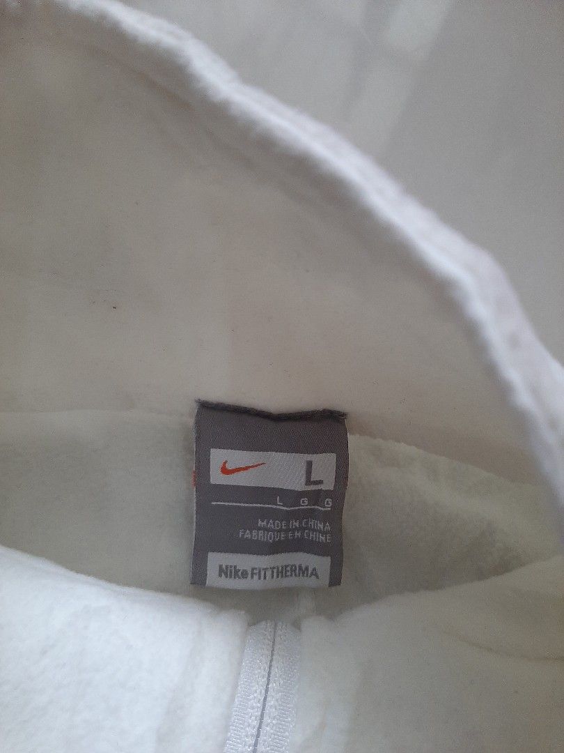 Nike Vest (Category: Vests) located in Siniloan. Submitted by rethr1ft (Listing ID 1405839993, Image 2). Description: - Nike sleeveless jacket vest - Size: L - Color: White with black trim and pocket - Features full zipper closure - Made in Thailand - Includes Japanese text on tag - Small Nike logo on chest.