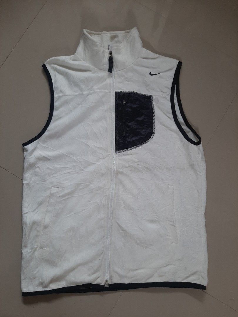 Nike Vest (Category: Vests) located in Siniloan. Submitted by rethr1ft (Listing ID 1405839993, Image 1). Description: - Nike sleeveless jacket vest - Size: L - Color: White with black trim and pocket - Features full zipper closure - Made in Thailand - Includes Japanese text on tag - Small Nike logo on chest.