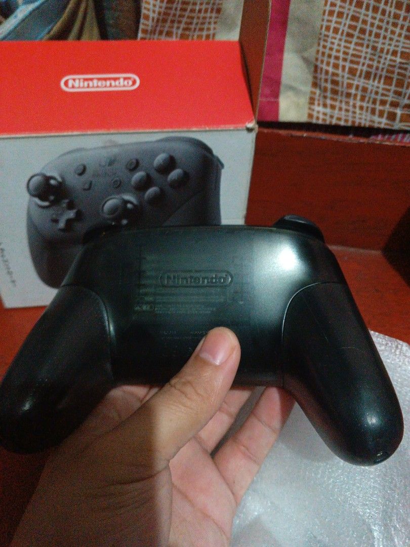 Nintendo Switch Pro Controller and accessories (Category: Controllers) located in San Juan City. Submitted by jeffstyle10 (Listing ID 1405752237, Image 2). Description: For sale Nintendo switch pro controller (black), joycon straps, game holder and amiibo Zelda mini card Issue for controller: Battery for replacement Negotiable Offer Reason for selling needs cash and sold switch consoles. Pick up House Location San Juan City.