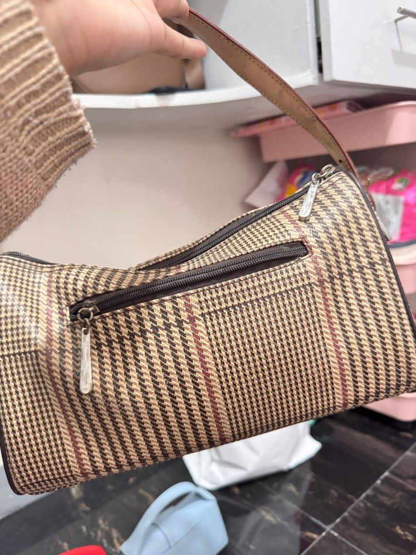Polo Ralph Lauren Handbag (Category: Luxury Bags & Wallets) located in Rosales. Submitted by thriftingismygame (Listing ID 1405760925, Image 2). Description: - Polo Ralph Lauren handbag - Plaid pattern with brown leather accents - Top handle - Front flap with two pockets - Zipper closure - Small metal logo - Interior label: Polo Ralph Lauren May few signs of usage lang given naman kasi vintage na. - Handle shows wear.