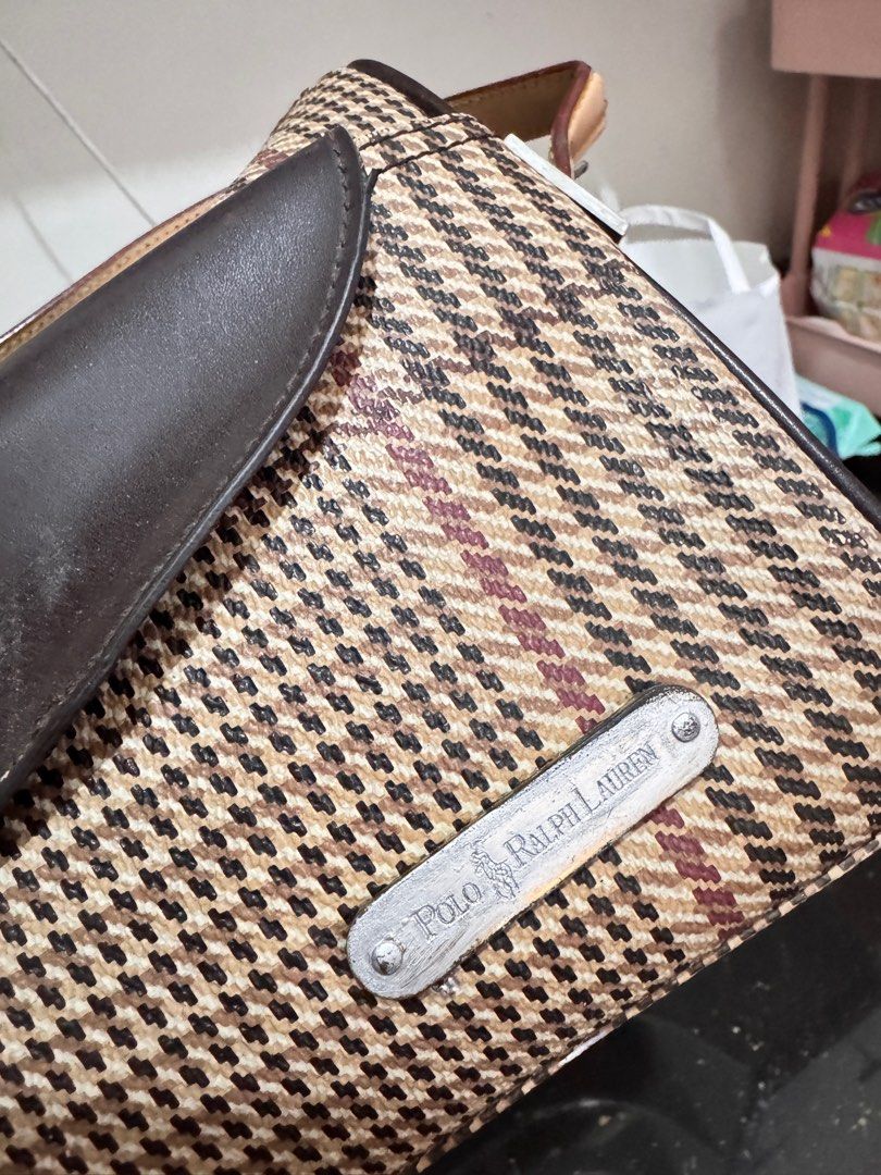 Polo Ralph Lauren Handbag (Category: Luxury Bags & Wallets) located in Rosales. Submitted by thriftingismygame (Listing ID 1405760925, Image 3). Description: - Polo Ralph Lauren handbag - Plaid pattern with brown leather accents - Top handle - Front flap with two pockets - Zipper closure - Small metal logo - Interior label: Polo Ralph Lauren May few signs of usage lang given naman kasi vintage na. - Handle shows wear.