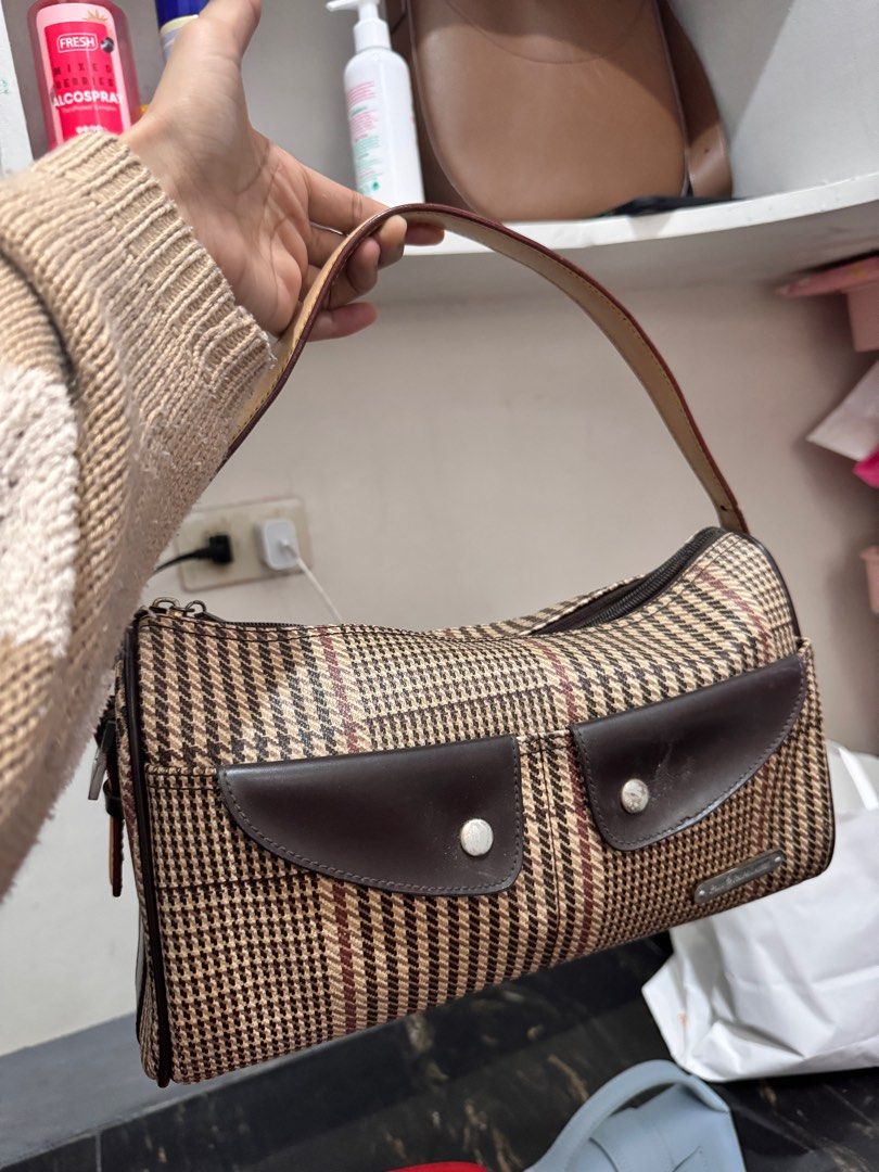 Polo Ralph Lauren Handbag (Category: Luxury Bags & Wallets) located in Rosales. Submitted by thriftingismygame (Listing ID 1405760925, Image 1). Description: - Polo Ralph Lauren handbag - Plaid pattern with brown leather accents - Top handle - Front flap with two pockets - Zipper closure - Small metal logo - Interior label: Polo Ralph Lauren May few signs of usage lang given naman kasi vintage na. - Handle shows wear.