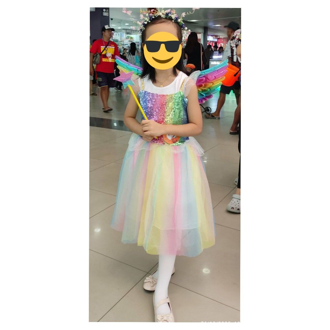 Rainbow Fairy Costume with Wings (Category: Babies & Kids Fashion) located in Iba. Submitted by LovedByMum (Listing ID 1405778802, Image 1). Description: - Adorable rainbow fairy costume - Features sequined bodice and rainbow tulle skirt - Includes matching wings, wand, and floral headband - Designed for children - Great for imaginative play and themed events.