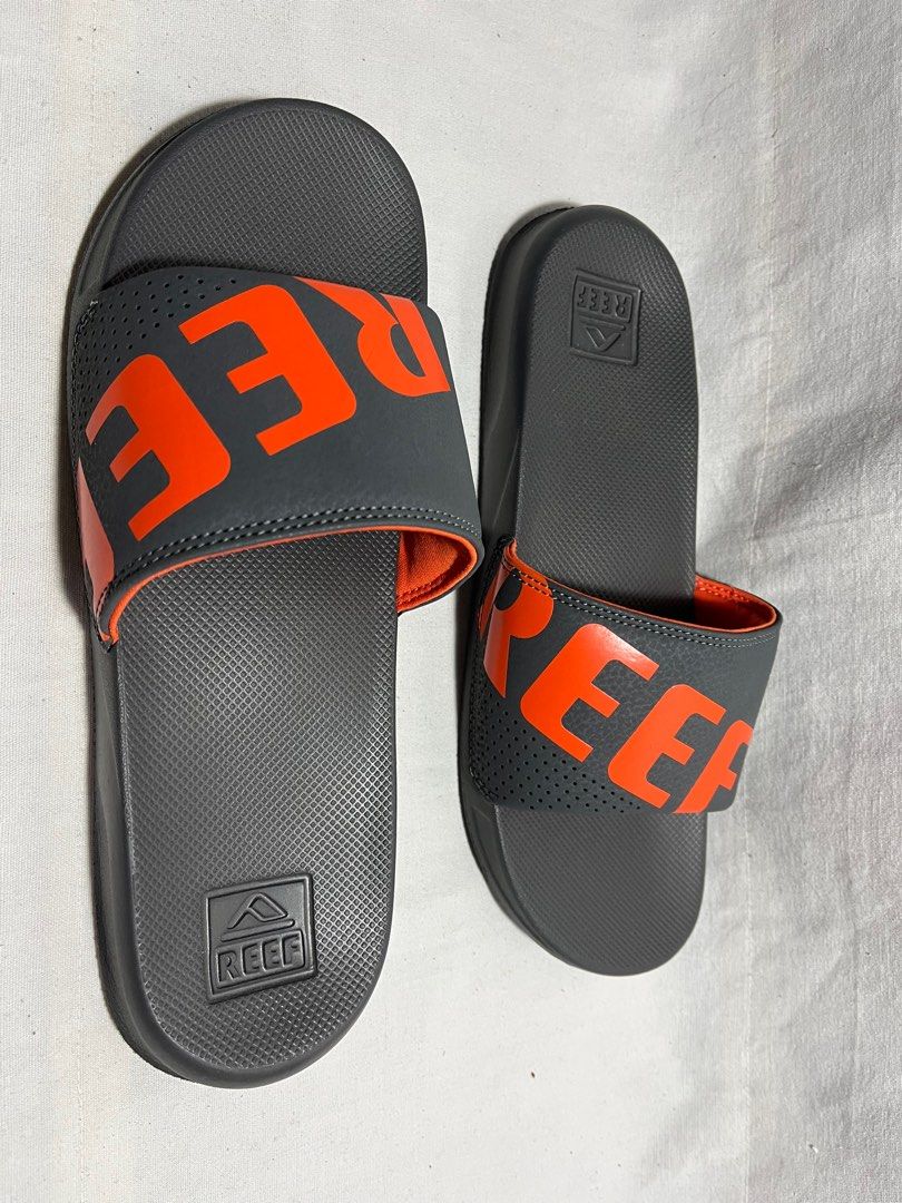 Reef One Slide Sandals - Grey/Orange (Category: Slippers & Slides) located in Antipolo. Submitted by gettinghooked (Listing ID 1405726576, Image 2). Description: - Reef One Slide sandals - Color: Grey with orange accents - Features Reef logo - Size: US Men's 8, UK 7, EUR 40, CM 26 - New with tags.