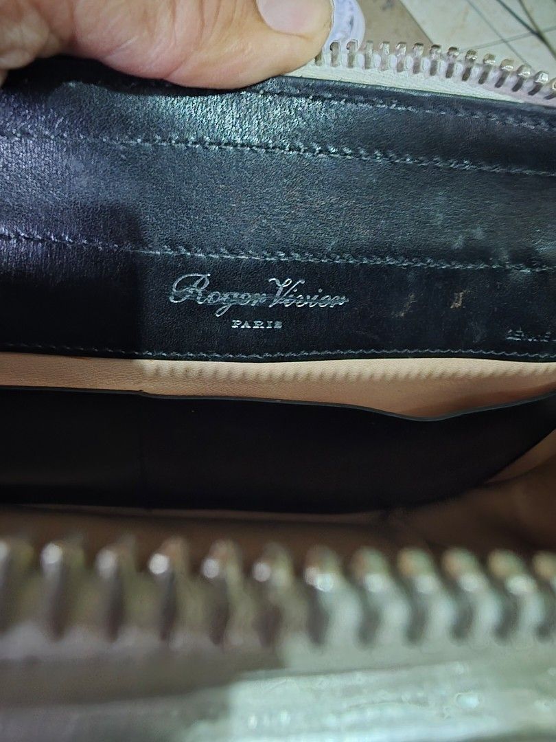Roger Vivier Paris Silver Shoulder Bag (Category: Luxury Bags & Wallets) located in Quezon City. Submitted by phoejay (Listing ID 1405726676, Image 1). Description: - Roger Vivier Paris shoulder bag - Silver metallic finish - White leather base - Silver-tone shoulder strap - Rectangular clasp - Black leather interior - Roger Vivier Paris logo - Zipper closure.