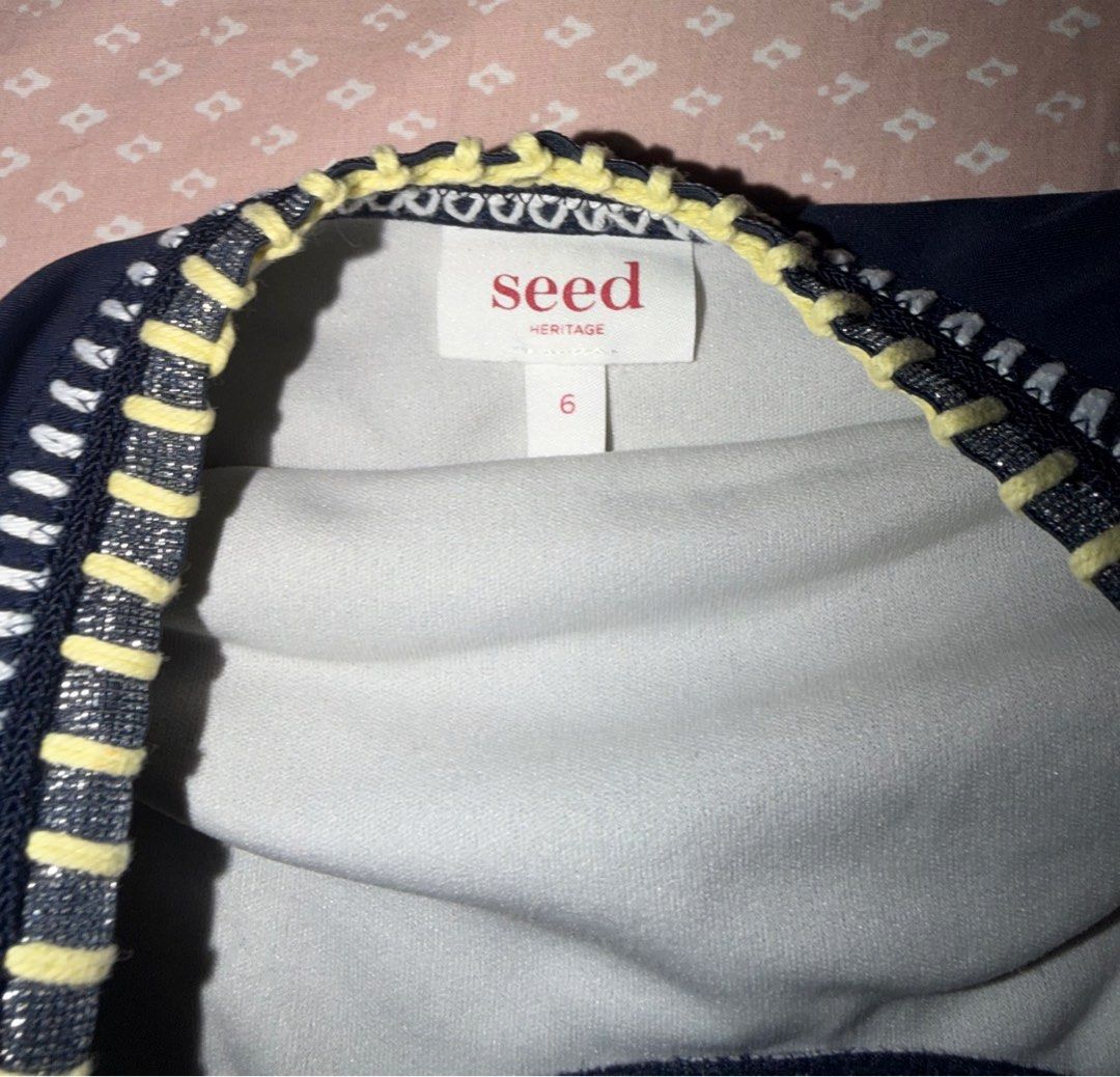 Seed Heritage Swimsuit Size 6 (Category: Babies & Kids Fashion) located in Tacloban City. Submitted by chaomg (Listing ID 1405877558, Image 2). Description: - Seed Heritage one-piece swimsuit - Color: Navy blue - Size: 6 - Decorative stitching in white, yellow, and pink - Smooth, solid fabric - Light grey inner lining MOP: GCash/Maya Payment (last price posted).