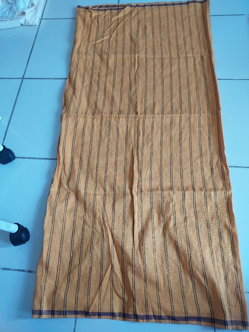 Tboli weaved cloth (Category: Bedding & Towels) located in Mandaluyong City. Submitted by declutterwithkinah (Listing ID 1405759554, Image 1). Description: - Striped pattern in orange and black - Rectangular shape - Made of soft material - Versatile for various uses.