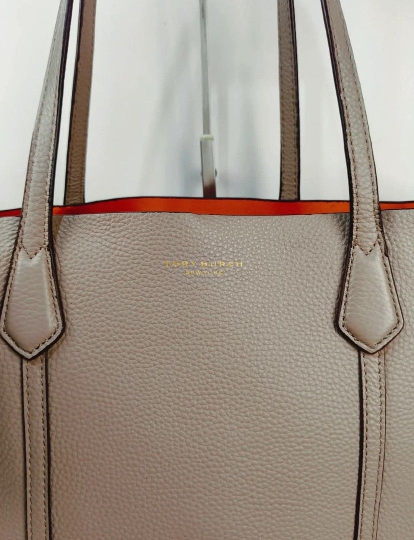 Tory Burch Perry Triple Compartment Tote (Category: Luxury Bags & Wallets) located in Digos. Submitted by chihanu (Listing ID 1405898717, Image 1). Description: - Tory Burch Perry Triple Compartment Tote - Color: Clam shell - Interior: Spacious with orange lining - Closure: Zip - Handles: Double top handles - Interior Pocket: 1 small pocket - Features the Tory Burch logo - Condition: Good.