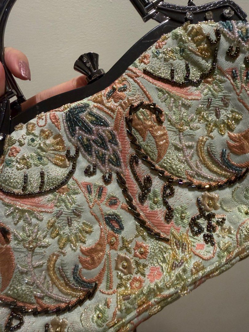 Vintage Embroidered Handbag (Category: Luxury Bags & Wallets) located in Las Pinas. Submitted by privari (Listing ID 1405850875, Image 3). Description: - Vintage handbag - Intricate floral embroidery in pastel colors - Structured frame with top handle - Detachable chain strap - Light-colored fabric lining - Small interior pocket - Embellished with beads and rhinestones.