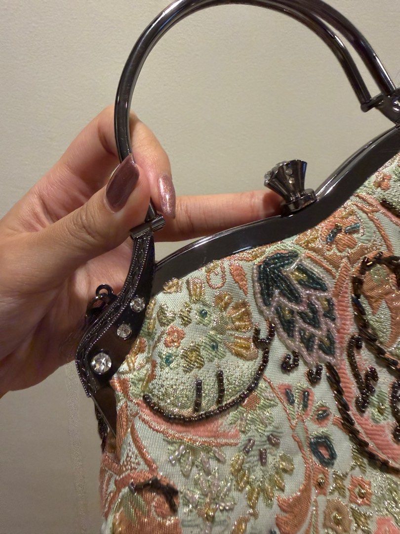 Vintage Embroidered Handbag (Category: Luxury Bags & Wallets) located in Las Pinas. Submitted by privari (Listing ID 1405850875, Image 2). Description: - Vintage handbag - Intricate floral embroidery in pastel colors - Structured frame with top handle - Detachable chain strap - Light-colored fabric lining - Small interior pocket - Embellished with beads and rhinestones.