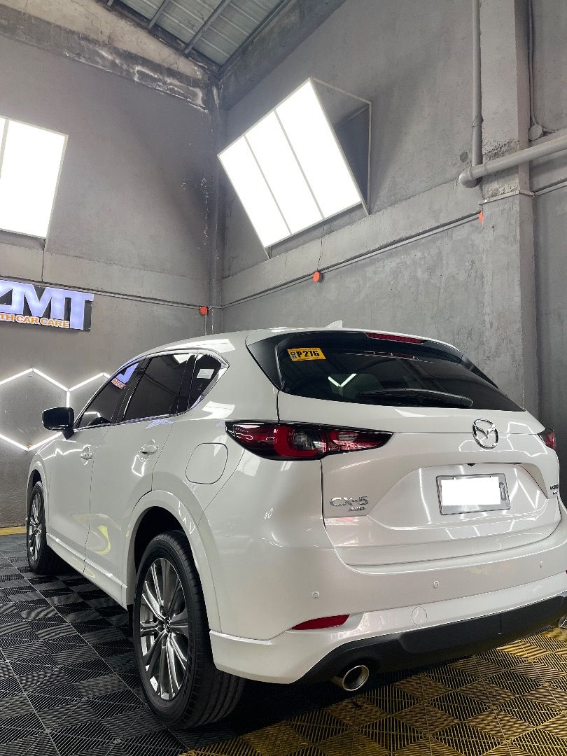 2024 Mazda CX-5 AWD Turbo (Category: Heavy Vehicles) located in Makati City. Submitted by deautotrading (Listing ID 1405941932, Image 3). Description: For sale: 2024 Mazda CX-5 AWD Turbo Gas Price: P2,000,000 Casa maintained No issues *Top of the line variant* - Rhodium White Premium - Dynamic Pressure Turbo SKYACTIV-G 2.5L - I-ACTIV All-Wheel Drive - Automatic w/ Sports Mode - G-Vectoring Control Plus - IGL Graphene Coatings (mags included) - Pu