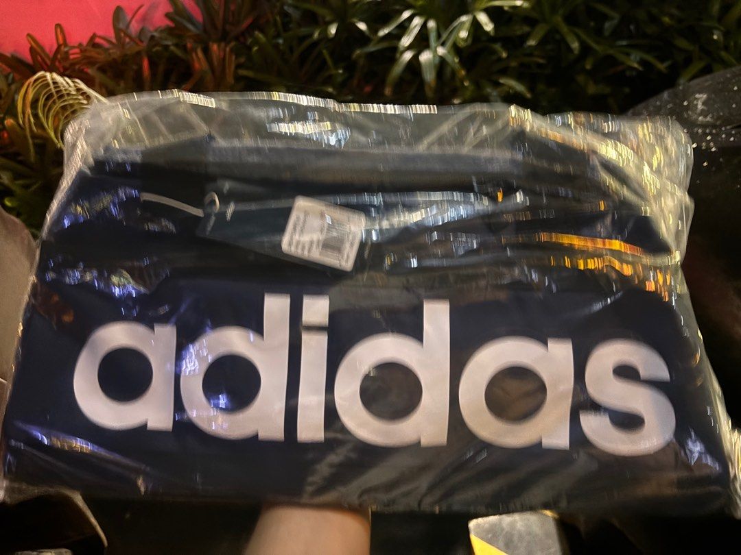 Adidas Linear Duffel S - Black/White (Category: Sling Bags) located in Pila. Submitted by eliphalez (Listing ID 1406022126, Image 1). Description: Adidas Linear Duffel S in blue and black.The bag is new and still in its original packaging. It has a large Adidas logo on the front. The price tag shows a price of PHP 1,500. Size:25L Brandnew Colorway: Pink/Blue/Green.