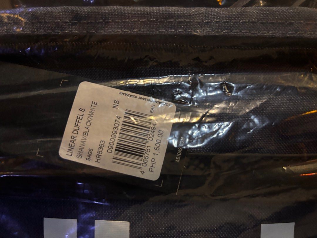 Adidas Linear Duffel S - Black/White (Category: Sling Bags) located in Pila. Submitted by eliphalez (Listing ID 1406022126, Image 3). Description: Adidas Linear Duffel S in blue and black.The bag is new and still in its original packaging. It has a large Adidas logo on the front. The price tag shows a price of PHP 1,500. Size:25L Brandnew Colorway: Pink/Blue/Green.